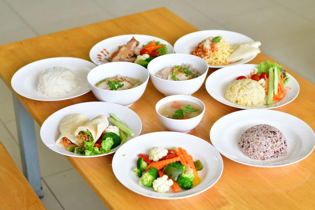 Home A variety of nutritious dishes displayed on a wooden table, showcasing diverse healthy meals.